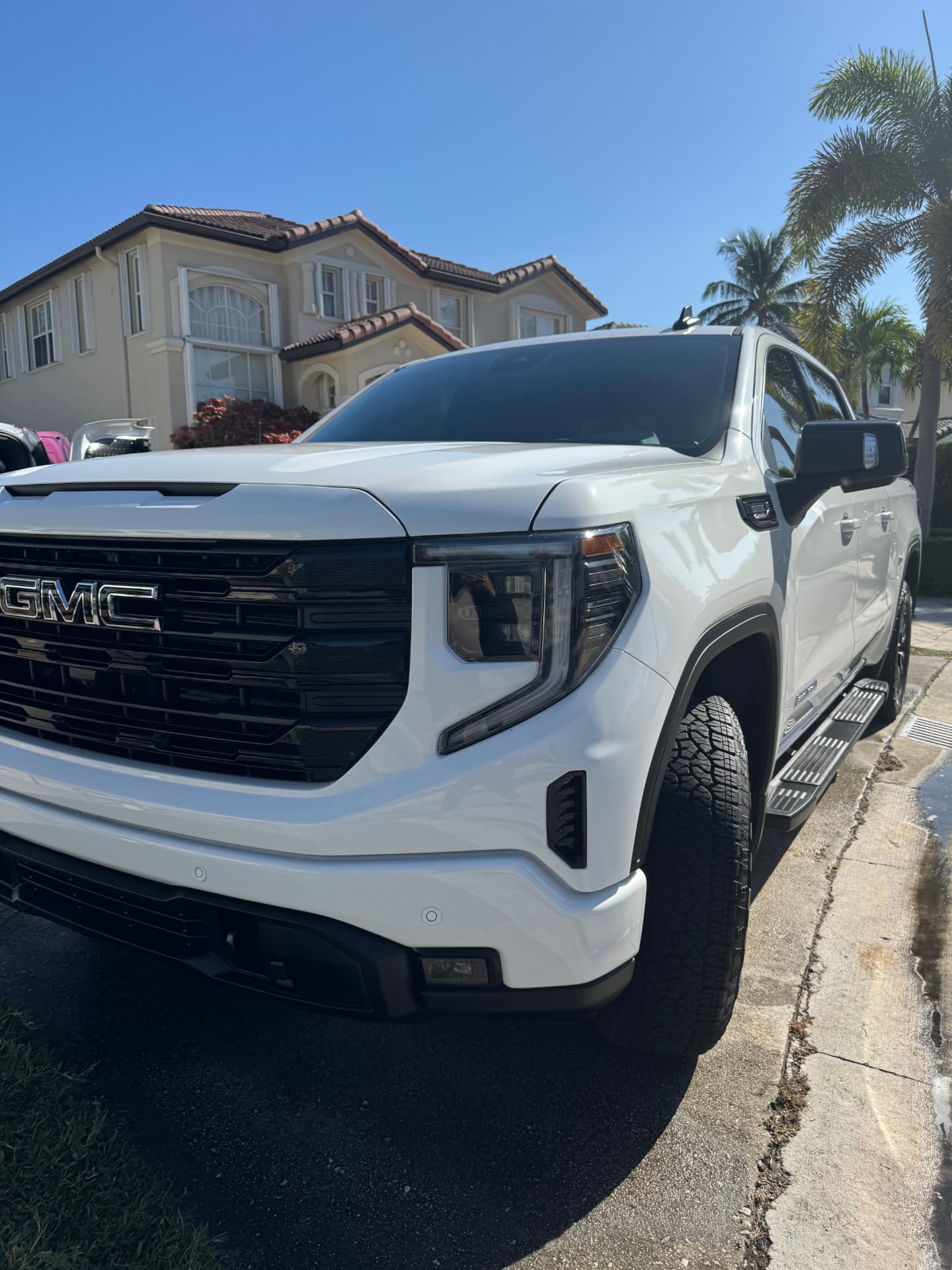 White pickup front three-quarter after a full exterior detail