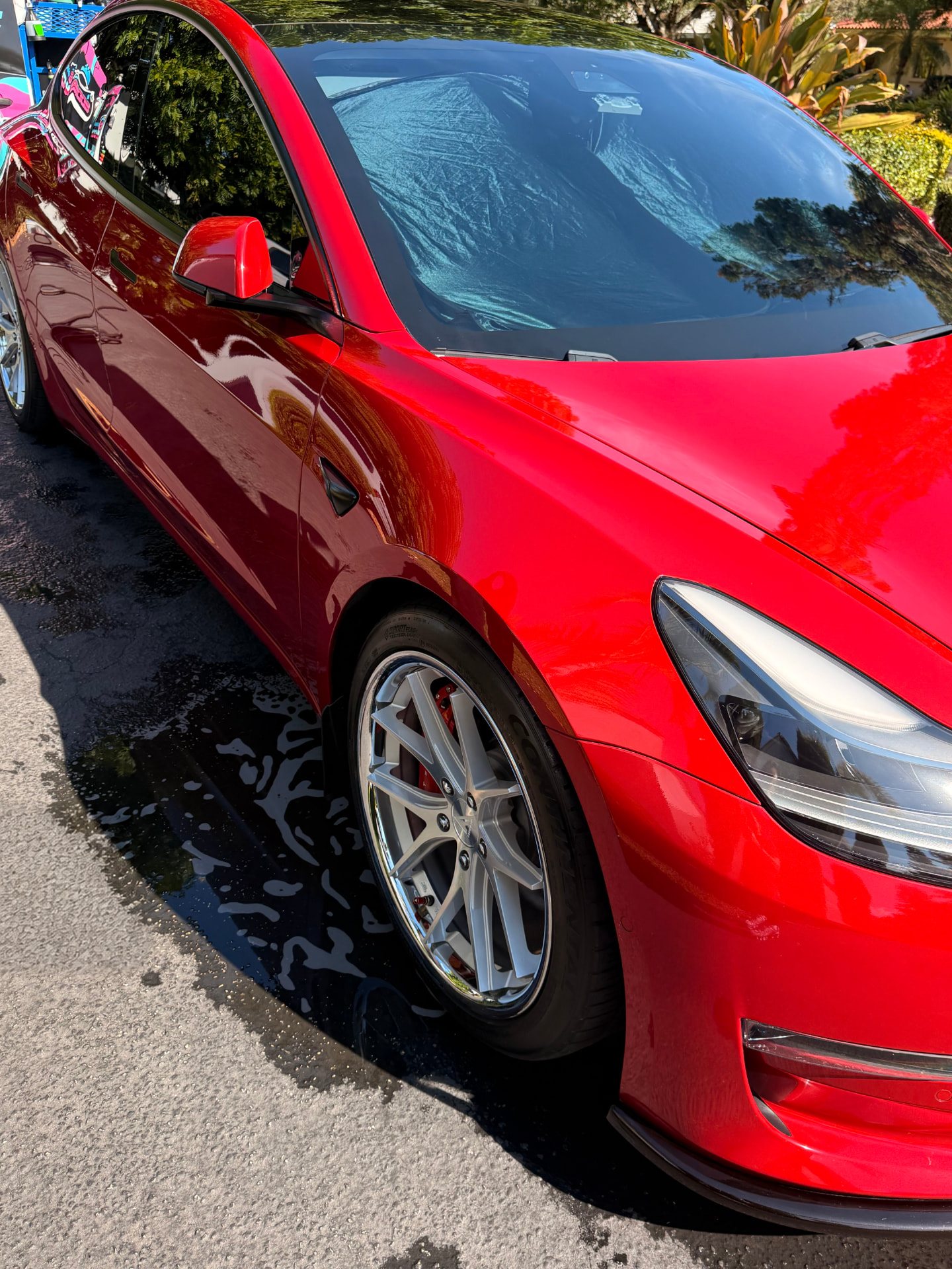 Red sports sedan, body panels and wheel finished by hand