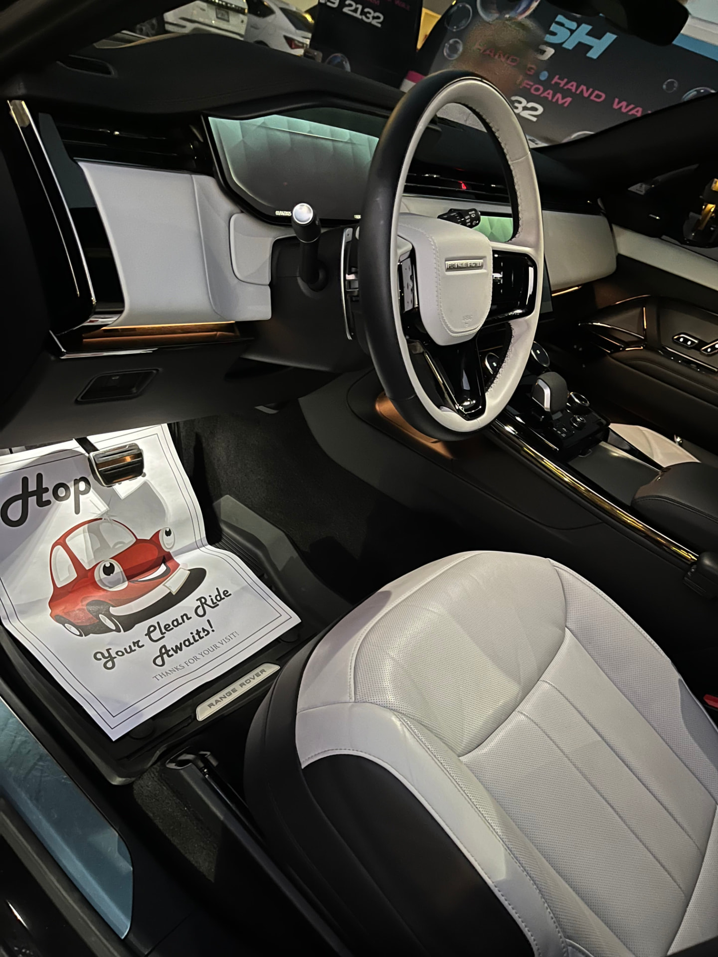 Dark SUV cabin, seats, console and door sills cleaned by hand