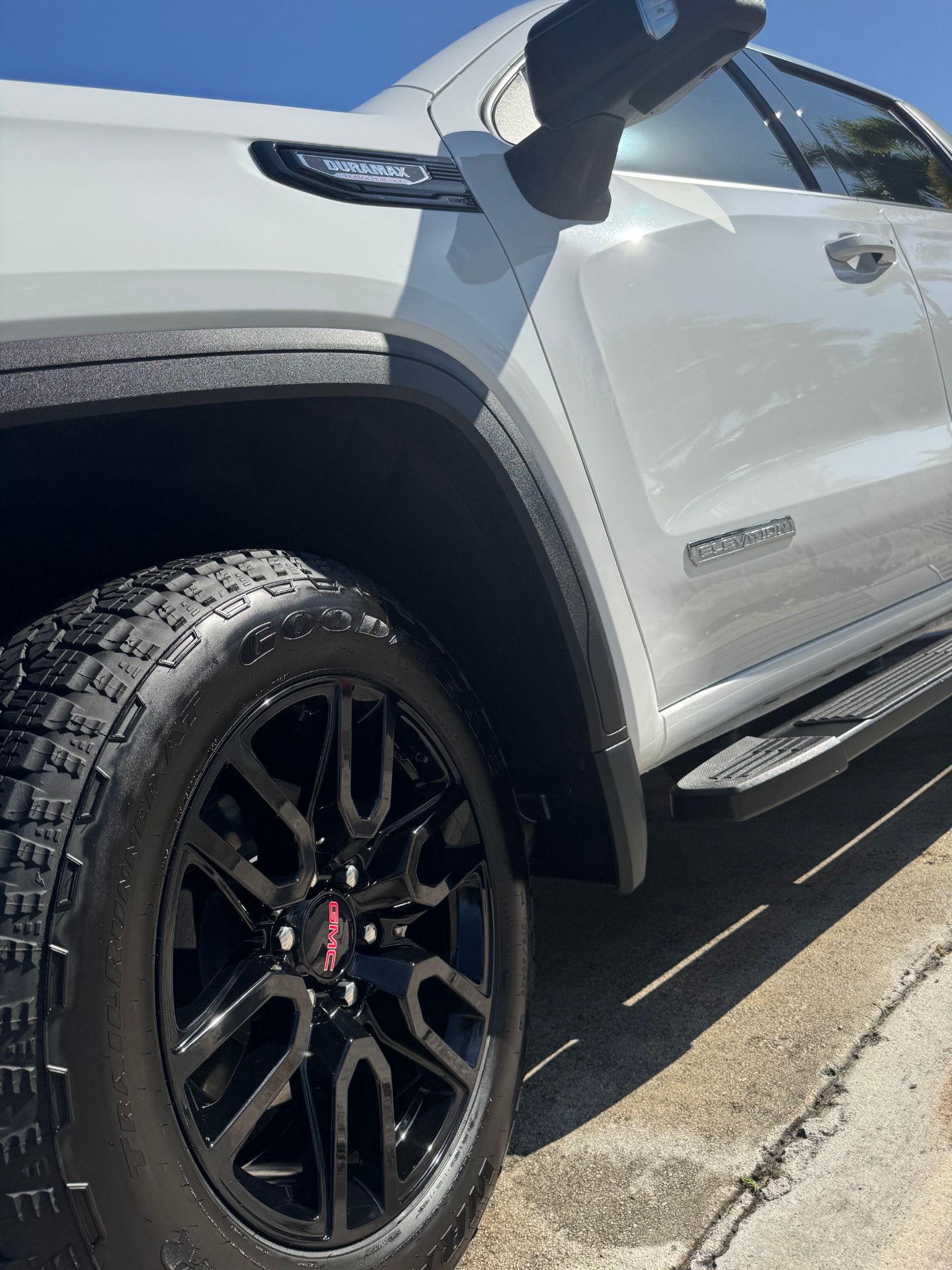 White pickup door, running board and wheel, wiped down and sealed